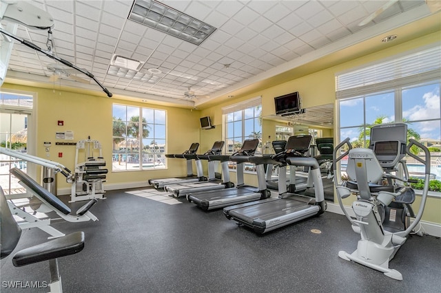 gym with a drop ceiling and ceiling fan