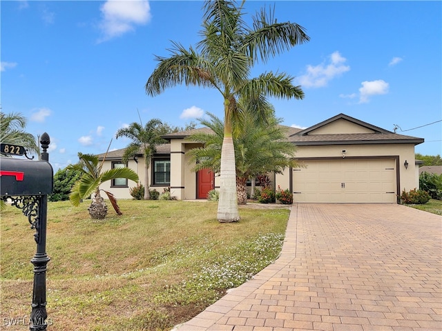 view of front facade with a front yard and a garage