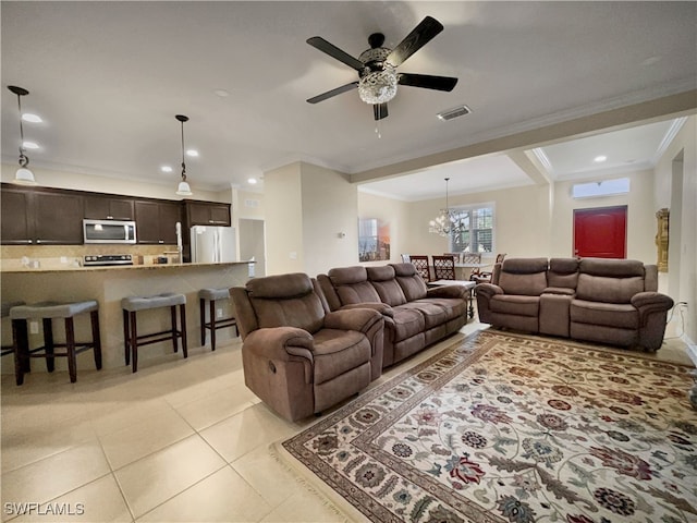 living room with ceiling fan with notable chandelier, an AC wall unit, ornamental molding, and light tile patterned flooring