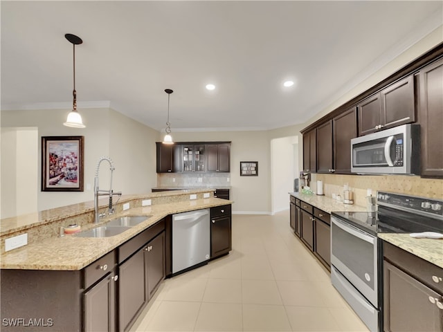 kitchen with hanging light fixtures, sink, stainless steel appliances, and dark brown cabinets