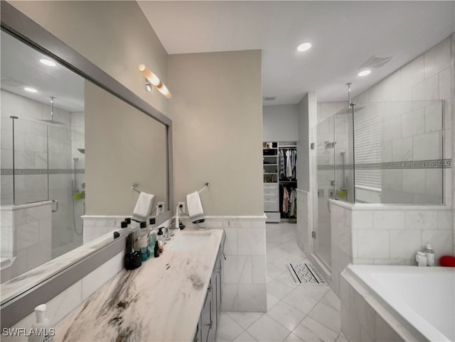 bathroom featuring separate shower and tub and vanity