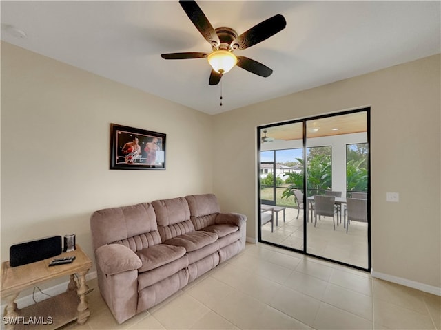 living room with ceiling fan and light tile patterned flooring