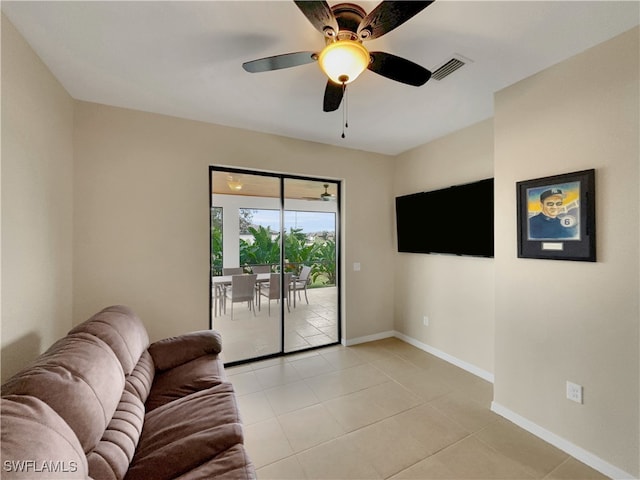 tiled living room with ceiling fan