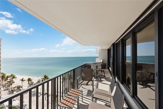 balcony featuring a water view and a view of the beach