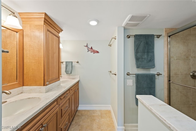 bathroom with tile patterned floors, vanity, and a shower with shower door