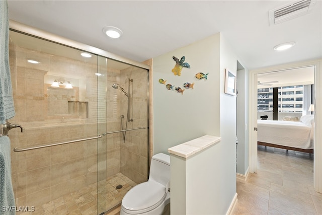 bathroom featuring tile patterned floors, toilet, and an enclosed shower