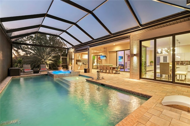 pool at dusk featuring glass enclosure, an in ground hot tub, and a patio