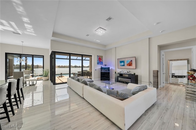 living room featuring a notable chandelier and light hardwood / wood-style flooring