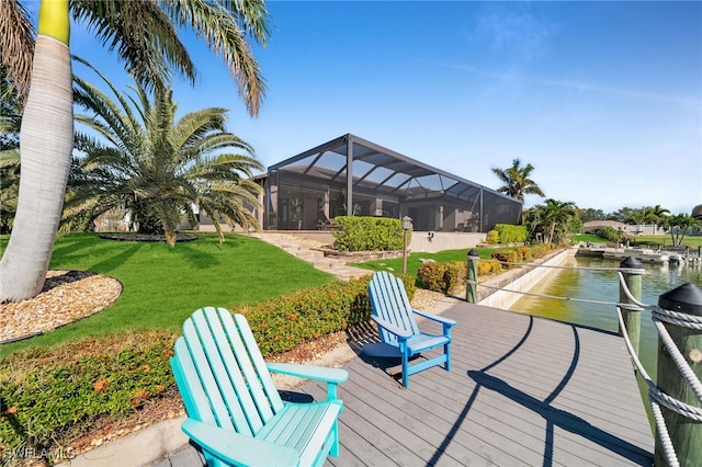 exterior space featuring a lawn, a dock, and a water view