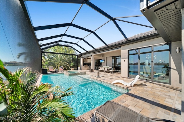 view of swimming pool featuring glass enclosure, an in ground hot tub, and a patio