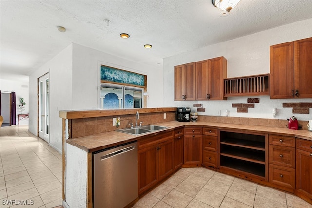 kitchen with kitchen peninsula, a textured ceiling, sink, dishwasher, and light tile patterned flooring