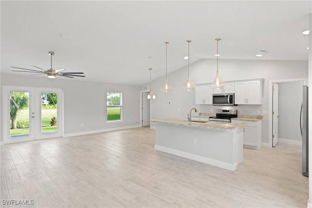 kitchen with pendant lighting, white cabinets, an island with sink, light stone counters, and stainless steel appliances