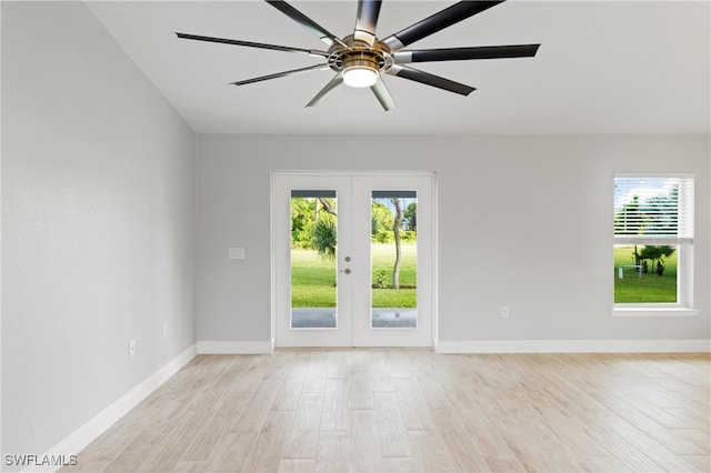 unfurnished room with a wealth of natural light, french doors, ceiling fan, and light hardwood / wood-style floors