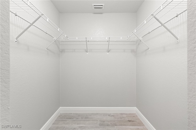 spacious closet featuring hardwood / wood-style flooring