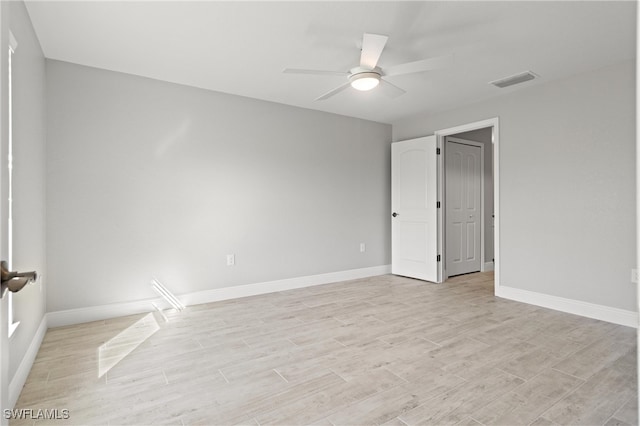 spare room featuring light hardwood / wood-style floors and ceiling fan