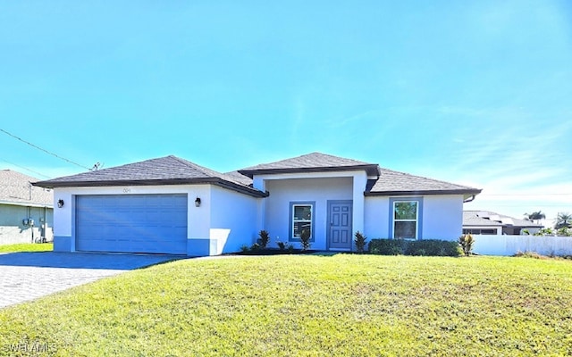 view of front of house with a front yard and a garage