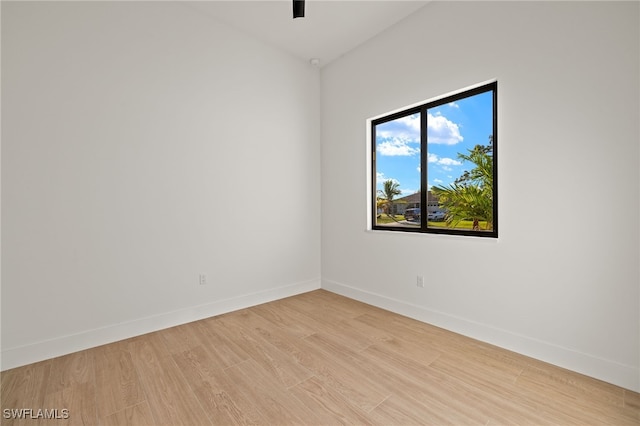 unfurnished room with light wood-style flooring and baseboards