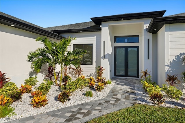 entrance to property with stucco siding and french doors