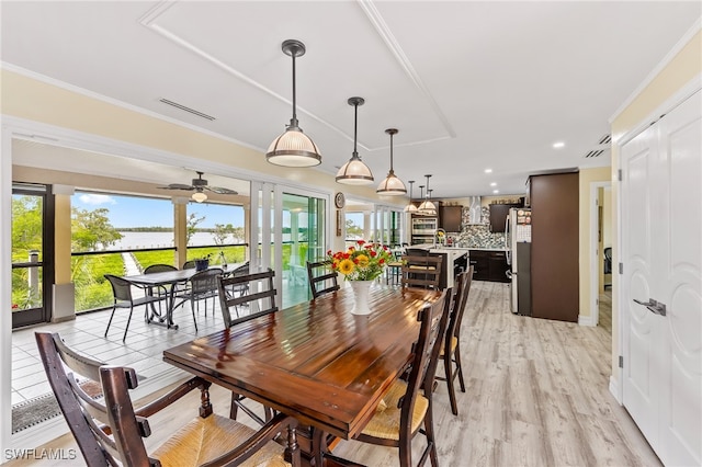 dining space featuring ceiling fan, light hardwood / wood-style flooring, and ornamental molding