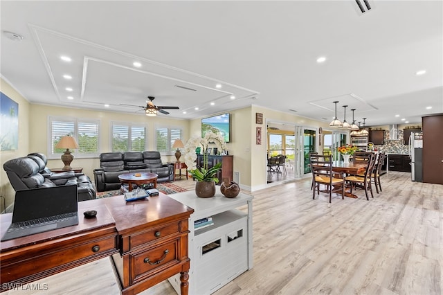 living room featuring light hardwood / wood-style flooring, ceiling fan, and ornamental molding