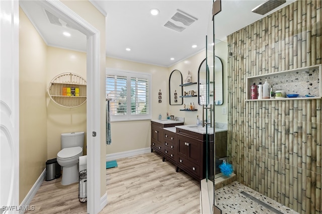 bathroom featuring crown molding, toilet, vanity, and hardwood / wood-style flooring