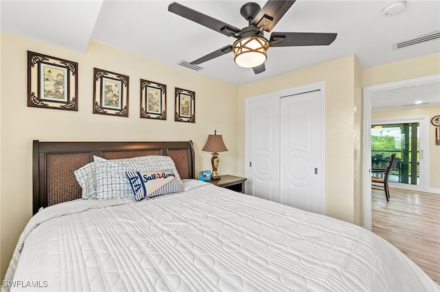 bedroom featuring access to exterior, ceiling fan, a closet, and light wood-type flooring