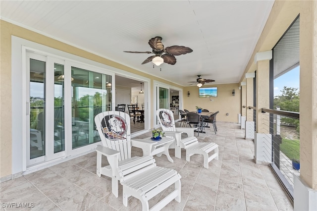 sunroom / solarium featuring ceiling fan