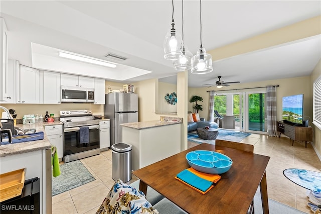 tiled dining room featuring ceiling fan