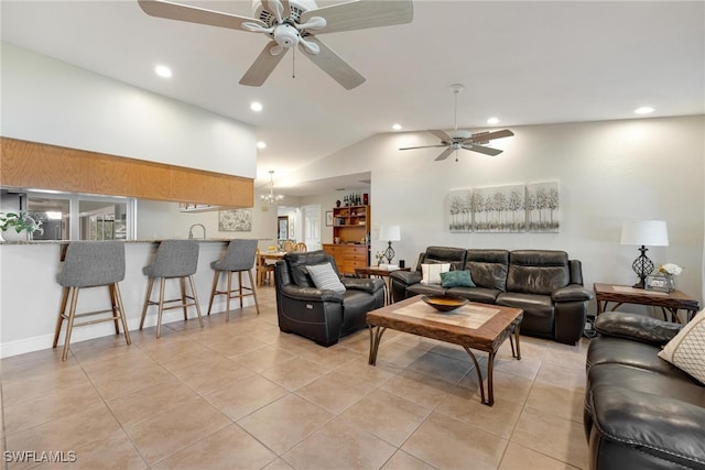 tiled living room with ceiling fan with notable chandelier, sink, and vaulted ceiling