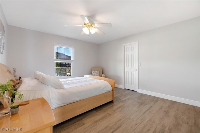 bedroom with ceiling fan and light wood-type flooring