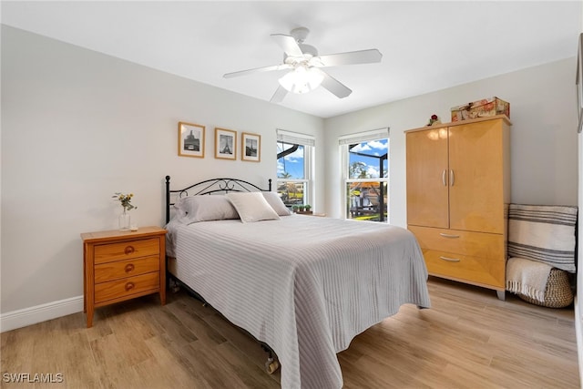 bedroom with ceiling fan and light hardwood / wood-style flooring