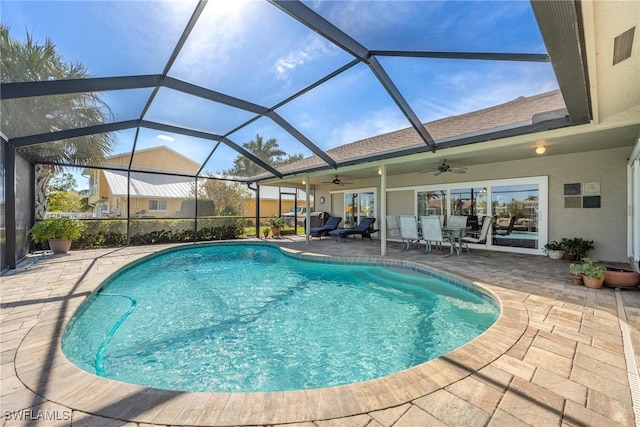 view of pool featuring a patio, ceiling fan, and a lanai