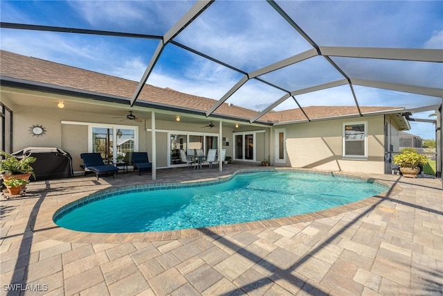 view of pool featuring a patio, ceiling fan, and a lanai