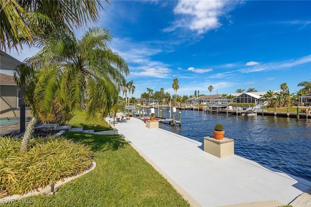 dock area with a yard and a water view