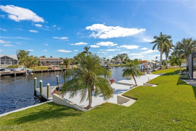 view of dock with a yard and a water view