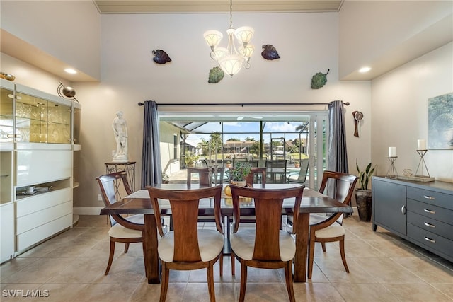 dining room featuring light tile patterned flooring, a towering ceiling, and a chandelier