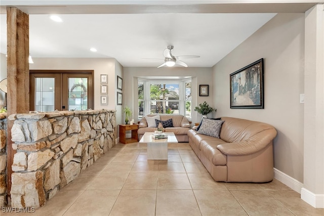 tiled living room featuring french doors and ceiling fan