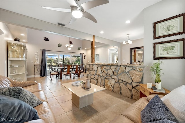 living room featuring ceiling fan with notable chandelier and light tile patterned flooring