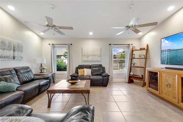 tiled living room featuring ceiling fan and plenty of natural light