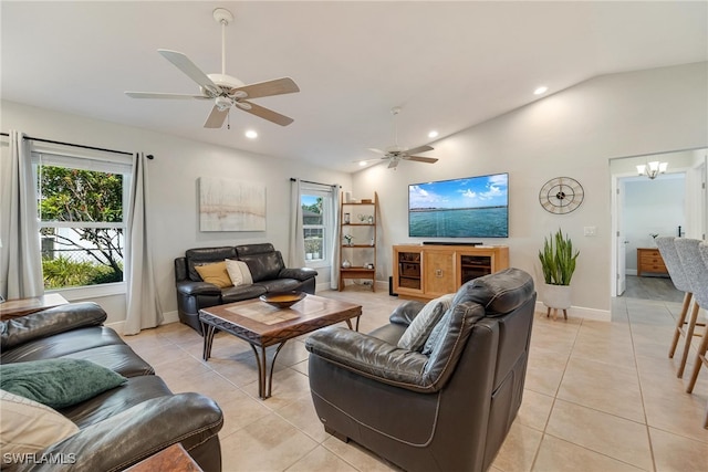 tiled living room featuring ceiling fan and vaulted ceiling