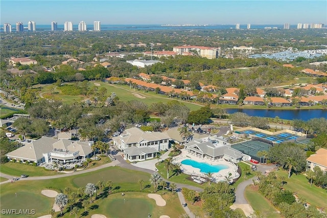 birds eye view of property with view of golf course, a water view, and a residential view