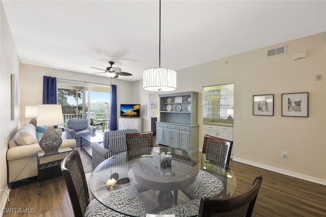 dining space featuring dark wood-style floors, visible vents, ceiling fan, and baseboards