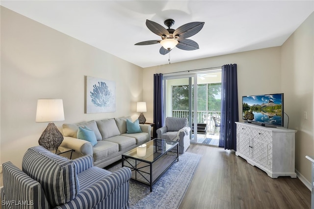 living area with dark wood-style floors, a ceiling fan, and baseboards