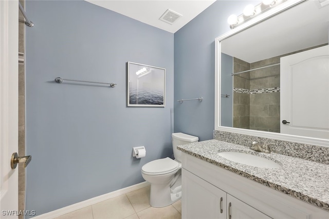 bathroom with visible vents, toilet, vanity, tile patterned flooring, and tiled shower