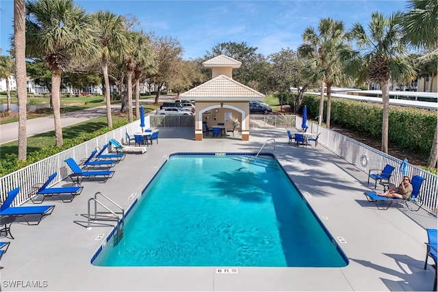 community pool featuring a gazebo, fence, and a patio