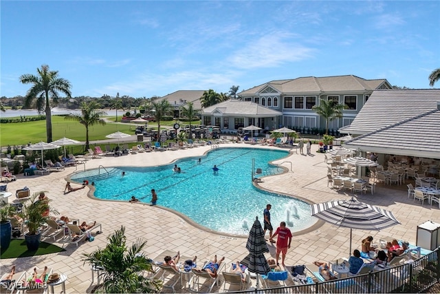 community pool featuring a patio and fence