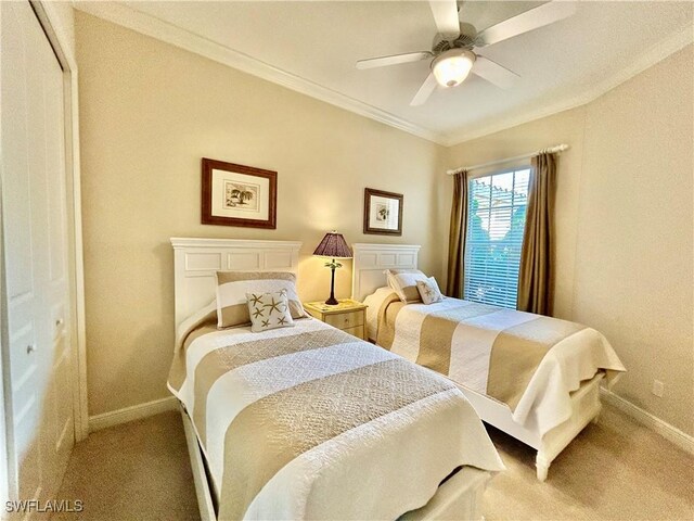 carpeted bedroom featuring crown molding and ceiling fan