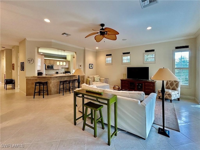 living room featuring crown molding, light tile patterned floors, and ceiling fan