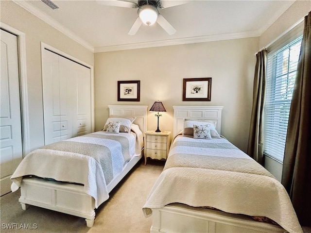 bedroom with ceiling fan, ornamental molding, and light carpet