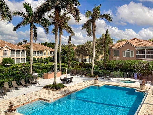 view of pool featuring a hot tub and a patio